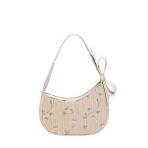 Beige straw hobo shoulder bag featuring floral embroidery and a large bow detail