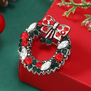Detailed macro of a festive Christmas wreath brooch set with red and green rhinestones