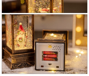 Detail of Christmas lantern snow globe with battery compartment and bronze frame finish