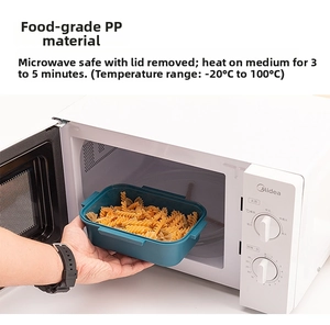 Placing a microwave-safe PP food container into microwave for heating pasta meal