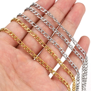 Close-up of gold and silver Figaro chain links for DIY jewelry making accessories