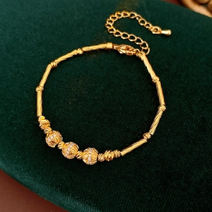 Detail of 18K gold-plated bamboo joint bracelet with three sparkling zircon spheres