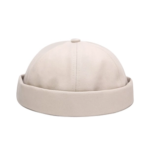 Unisex beige cotton docker hat with minimalist rolled cuff and twill fabric texture