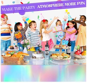 Irridescent silver laser tablecloth on party table with kids celebrating in the background