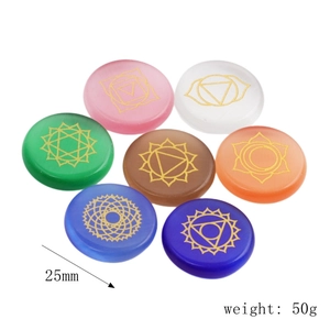 Detailed view of seven chakra energy stones with gold engraved symbols and 25mm size