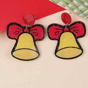 Macro shot of festive Christmas bell earrings with red bows and glitter details