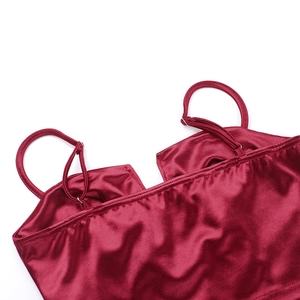 Detail of adjustable straps and silk satin fabric on a wine red camisole top