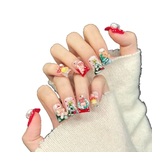 Handmade Christmas press-on nails featuring 3D gingerbread man and tree festive designs