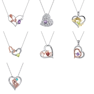 Detail view of heart pendants featuring colorful zircons and emotional mother engravings
