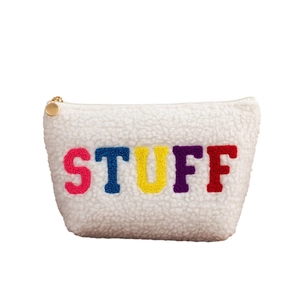 White plush fleece makeup bag with colorful STUFF chenille embroidery and gold zipper