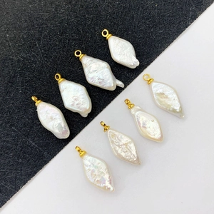 Set of 7 natural freshwater baroque pearl pendants with gold hooks on monochrome background