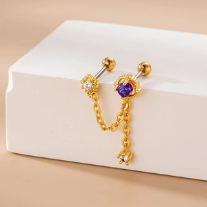 Gold double chain stud earring with purple zircon and white crystal charms on white block