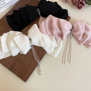 Elegant layered lace bow hair clips with rhinestone tassels in black, pink, and cream white