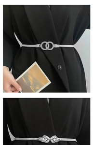 Detail of silver elastic metal waist chains with double-ring and bow buckle designs