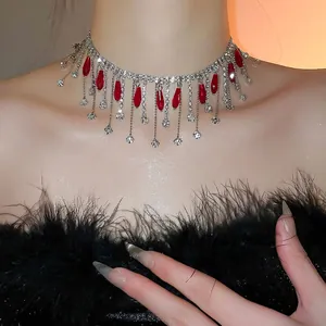 Elegant crystal choker necklace with red teardrop pendants and silver tassel details