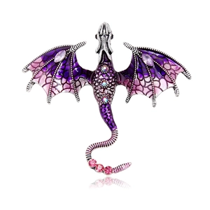 Vintage purple dragon brooch pin with rhinestones and enamel wings on a white background