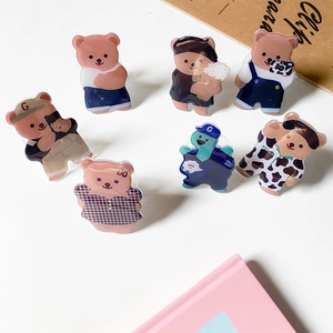 Close-up of cute cartoon bear acrylic phone grips in various colorful designs