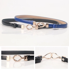Detail of thin black and blue interlocking waist belts with golden metal buckles
