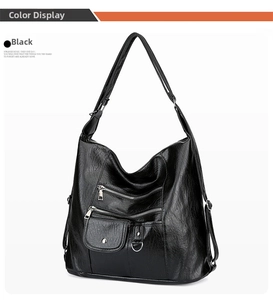Detail view of black vintage leather crossbody bag with multiple zipper pockets