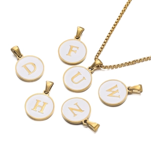 Detail of round gold alphabet pendants with white enamel and matching square link chain