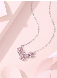 Detailed view of S925 sterling silver chain with three pink zircon flower pendants