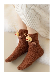 Detailed view of warm brown coral fleece socks with 3D Christmas reindeer plush doll