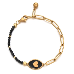 Detail of beaded bracelet with black faceted stones and gold heart oval pendant