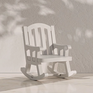 Miniature white wooden rocking chair ornament with Adirondack back on marble surface