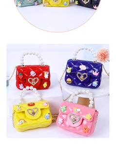 Detail view of colorful jelly handbags with pearl handles and cute cartoon charms