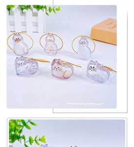 Macro shot of transparent cat-shaped capsule keychain for pet hair storage with gold ring