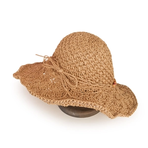 Detail of hand-woven straw sun hat showing hollow texture and colorful beads bow