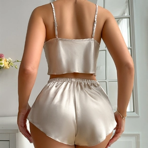 Women's champagne satin lingerie set featuring halter top and ruffled shorts sleepwear