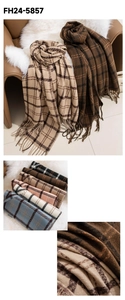 Detail of soft plaid scarf with fringe edge showing warm cashmere-like fabric texture