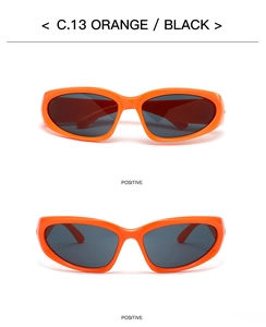 Detail view of bold orange sports sunglasses with wrap-around frames and dark black lenses