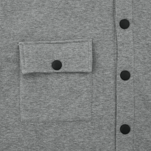 Detail of grey slim fit jacket featuring a flap pocket and black matte buttons