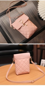 Detailed shot of pink quilted phone bag with golden cat ear ring and pearl pendants