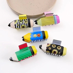 Whimsical pencil-shaped hair claws set featuring daisy and smiley face patterns