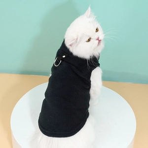 Close-up of black fleece pet vest featuring a durable metal D-ring for leash attachment