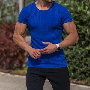 Close-up of blue slim-fit knit t-shirt with vertical ribbed texture and muscle fit