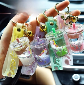 Close-up of unicorn liquid glitter keychains in colorful drink cup shapes with bells