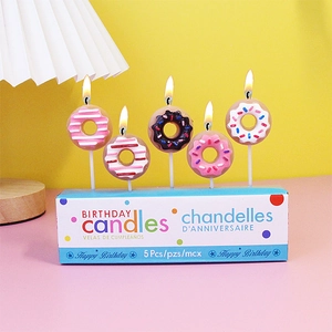 Set of 5 colorful donut-shaped birthday candles on a blue base for party cake decor