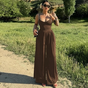 Detail of loose fit brown backless jumpsuit featuring spaghetti straps on a summer day