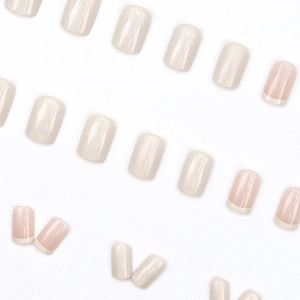 Short square press-on nails in cream and French pink style on a clean white background