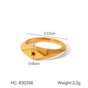 Detailed view of gold starburst ring with red gem featuring weight and size specs