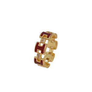 Gold plated ring featuring letter H links with dark red enamel and sparkling zircons