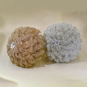 Detailed view of handmade crystal bridal bouquet accents in gold and silver plating