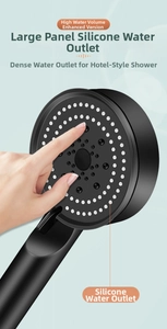 Close-up of the large matte black shower head with soft silicone nozzles for high flow