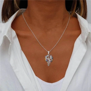 Detailed view of a silver firebird phoenix necklace with colorful crystal on a model