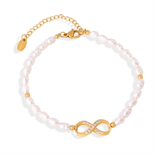 Freshwater pearl bracelet with a gold infinity charm and rhinestones on a white surface