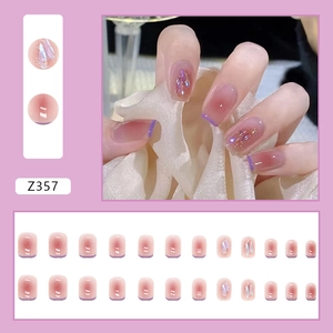 Detail of pink gradient press-on nails with purple French tips and aurora glitter